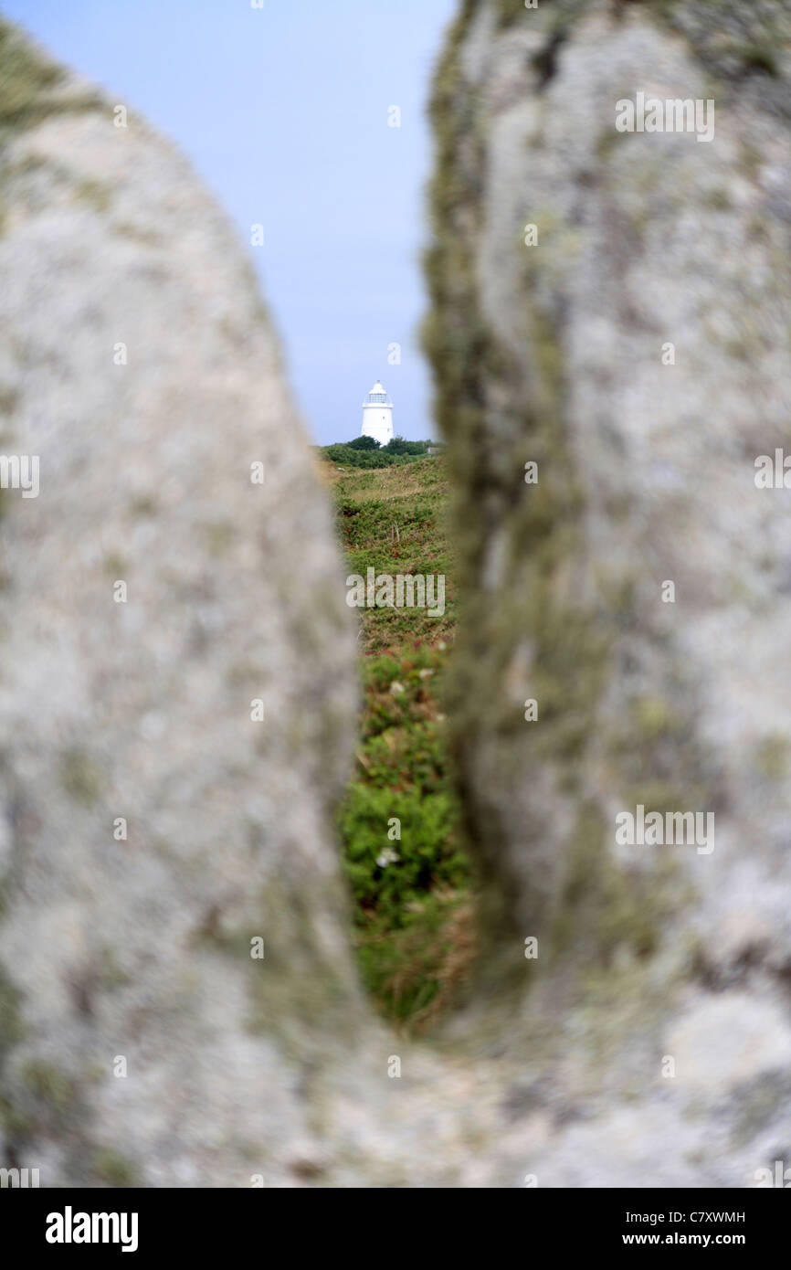 St Agnes Isles of Scilly lighthouse seen through the strange rock formations Stock Photo