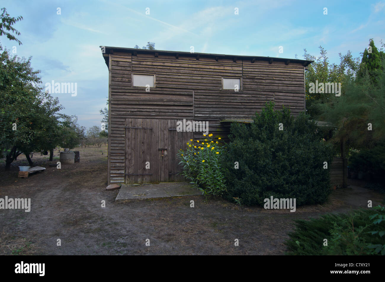 Small wooden summer house with yellow flowers Stock Photo - Alamy