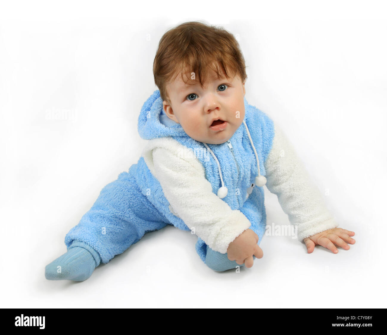 Small seven-month baby-boy It holds the foot. Isolated on white Stock