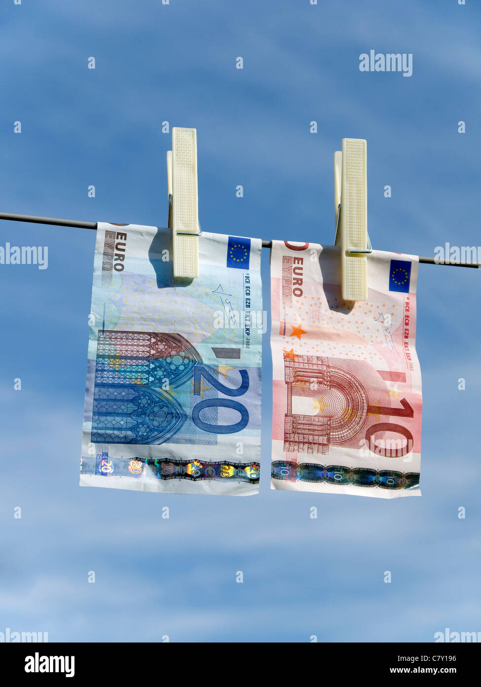 Concept representing money laundering Euro 20 and Euro 10 notes pegged on a washing line Stock Photo