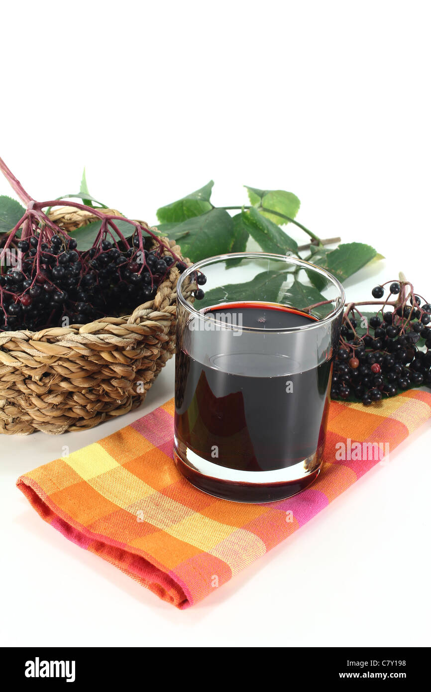 Elderberry juice with elder berries and leaves on a white background