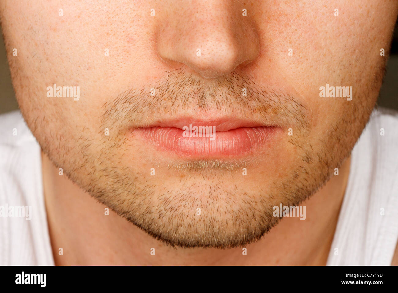 Close up of man's face sporting a 5 o'clock shadow Stock Photo