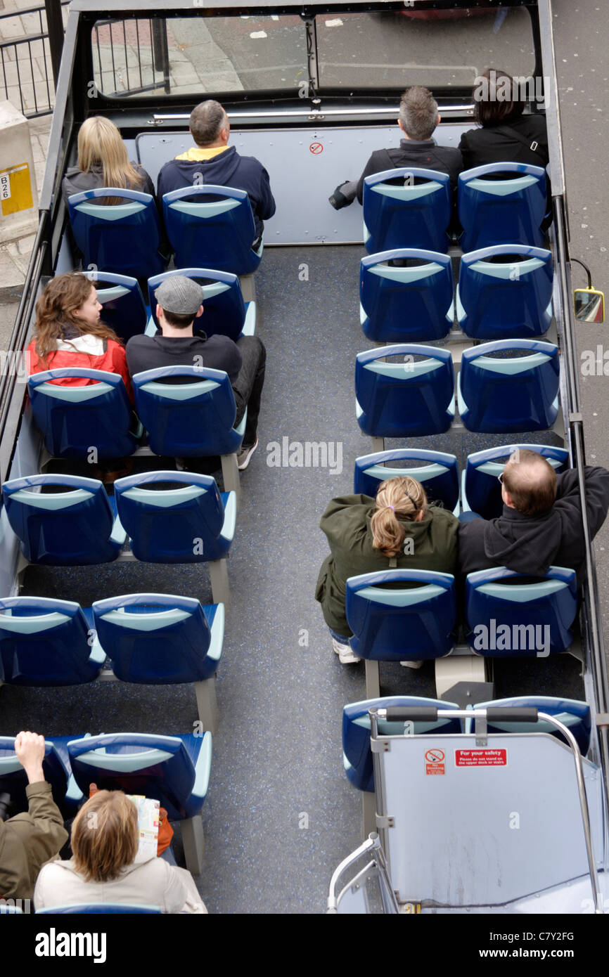 People on upper deck of London tour Bus, London, England, UK Stock Photo