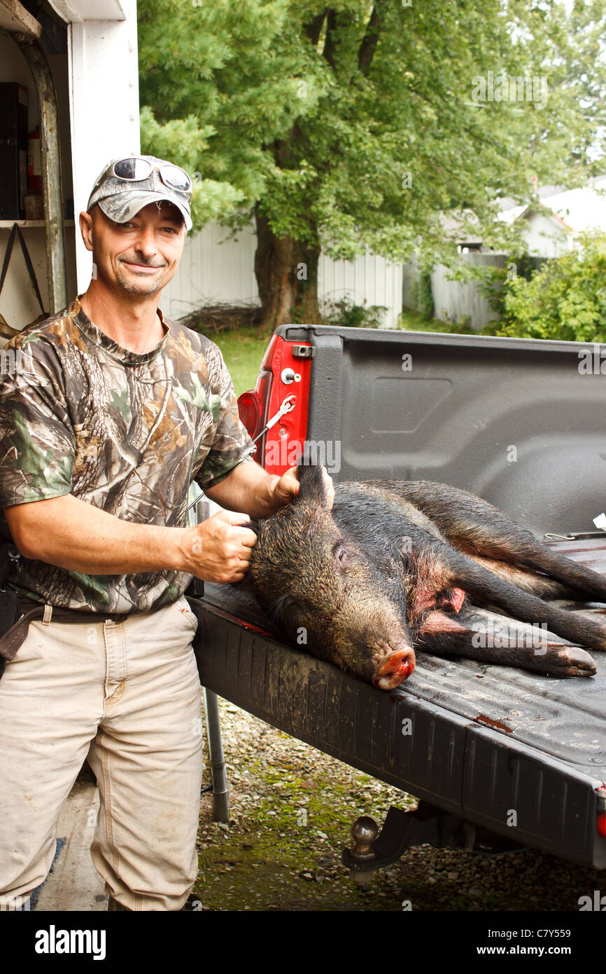 Hunter proudly showing his killed boar Stock Photo
