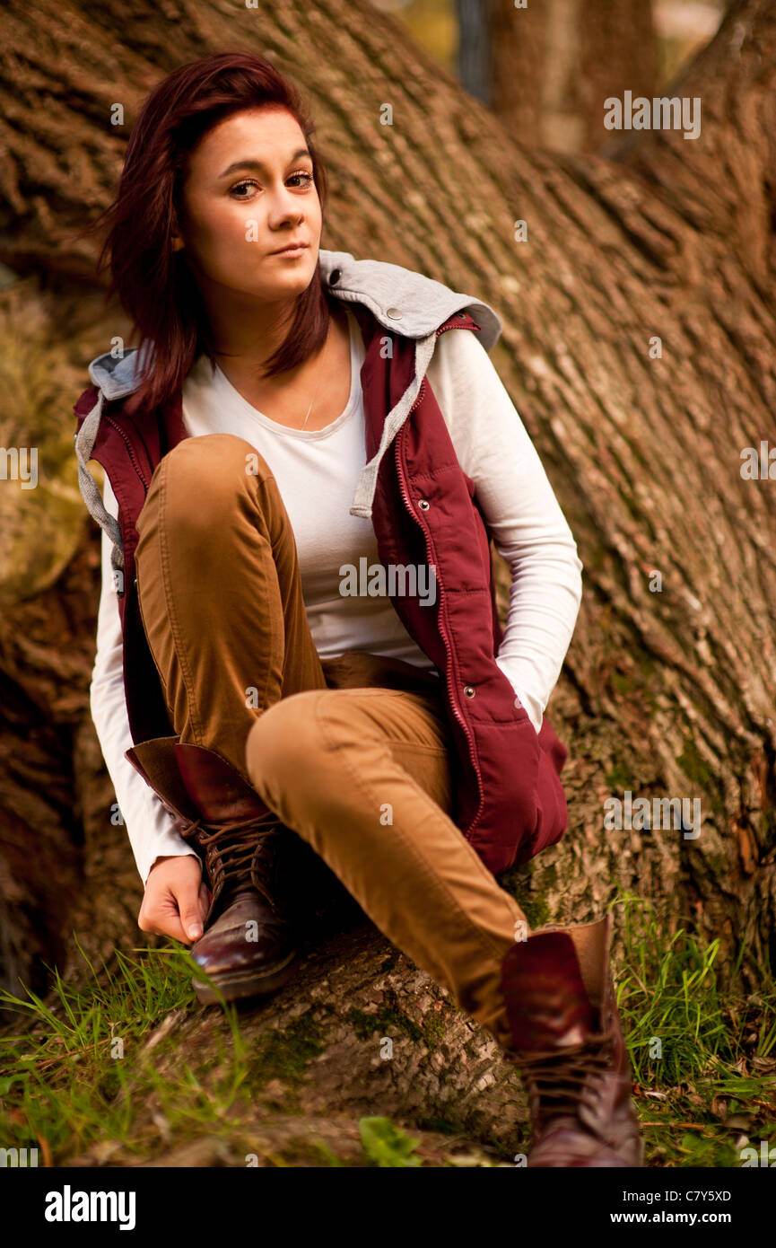 A 14 15 year old caucasian teenage girl , UK, outdoors, autumn, woodland Stock Photo