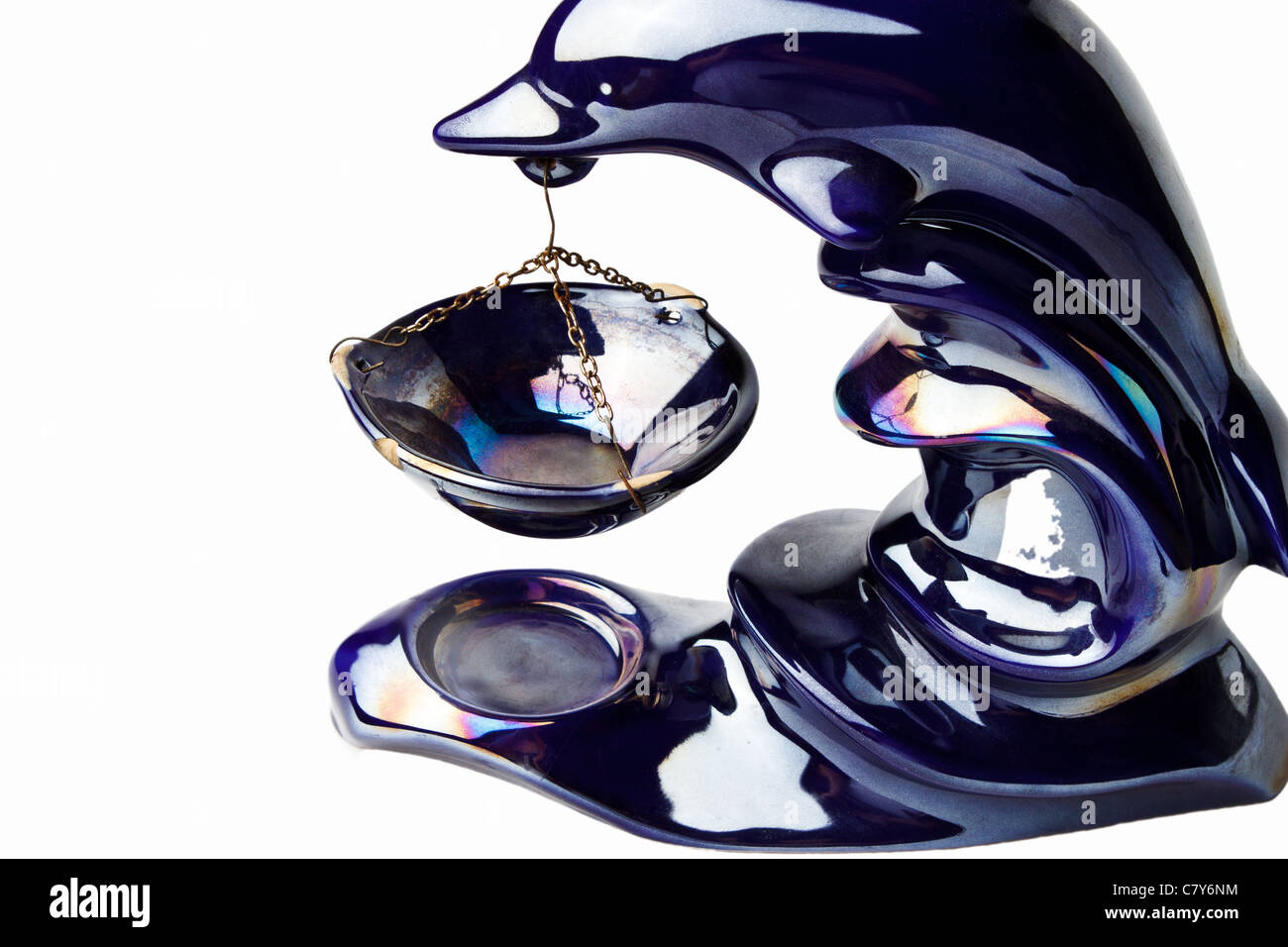Close-up of dolphin oil burner isolated against white background Stock Photo