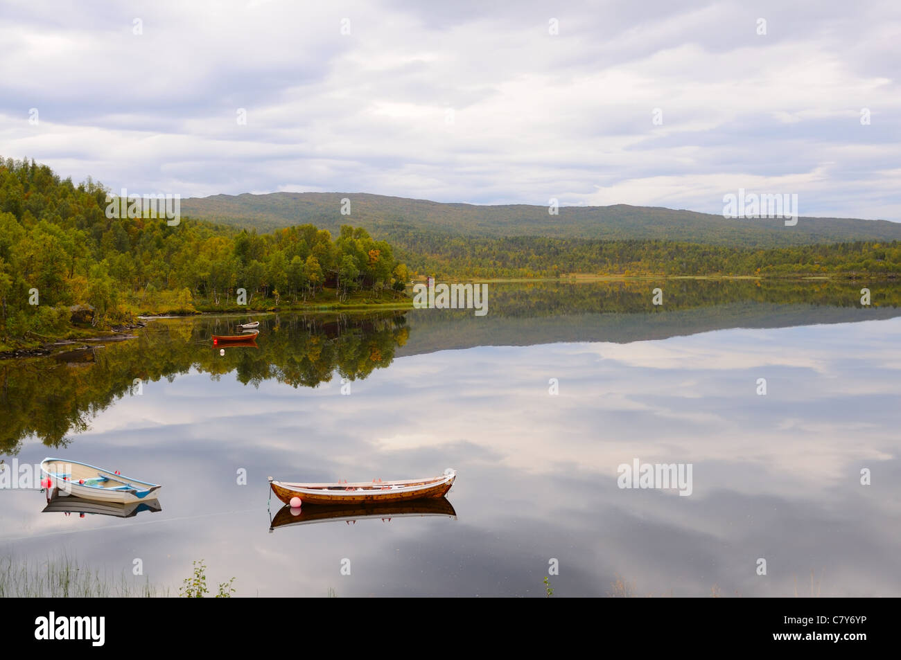 Mountain lake with boats in the autumn in Norway Stock Photo