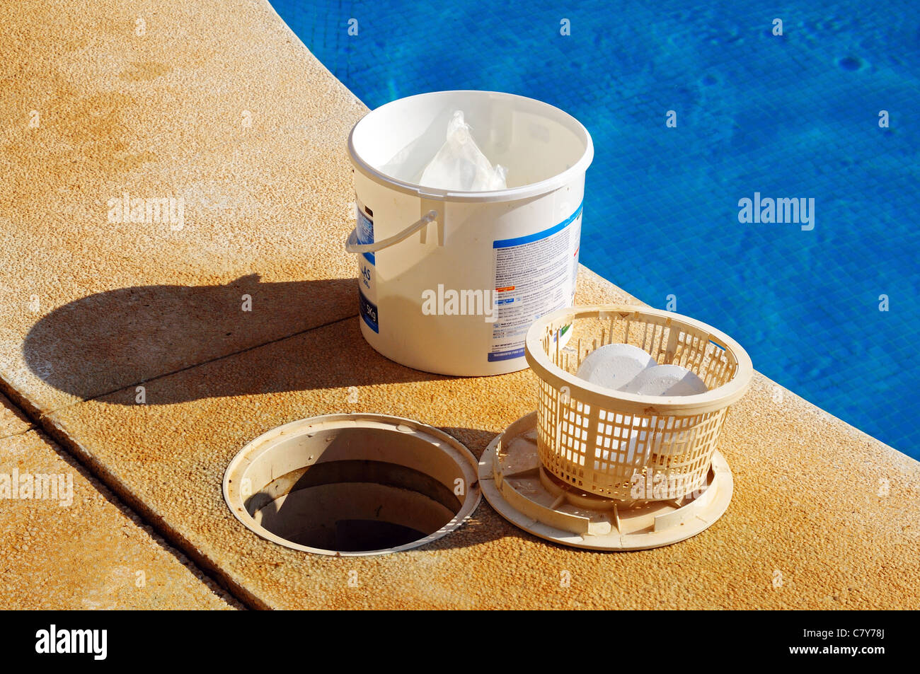 Pool chlorine tablets in basket and tub at poolside, Calahonda, Mijas Costa, Costa del Sol, Andalucia, Spain, Western Europe. Stock Photo