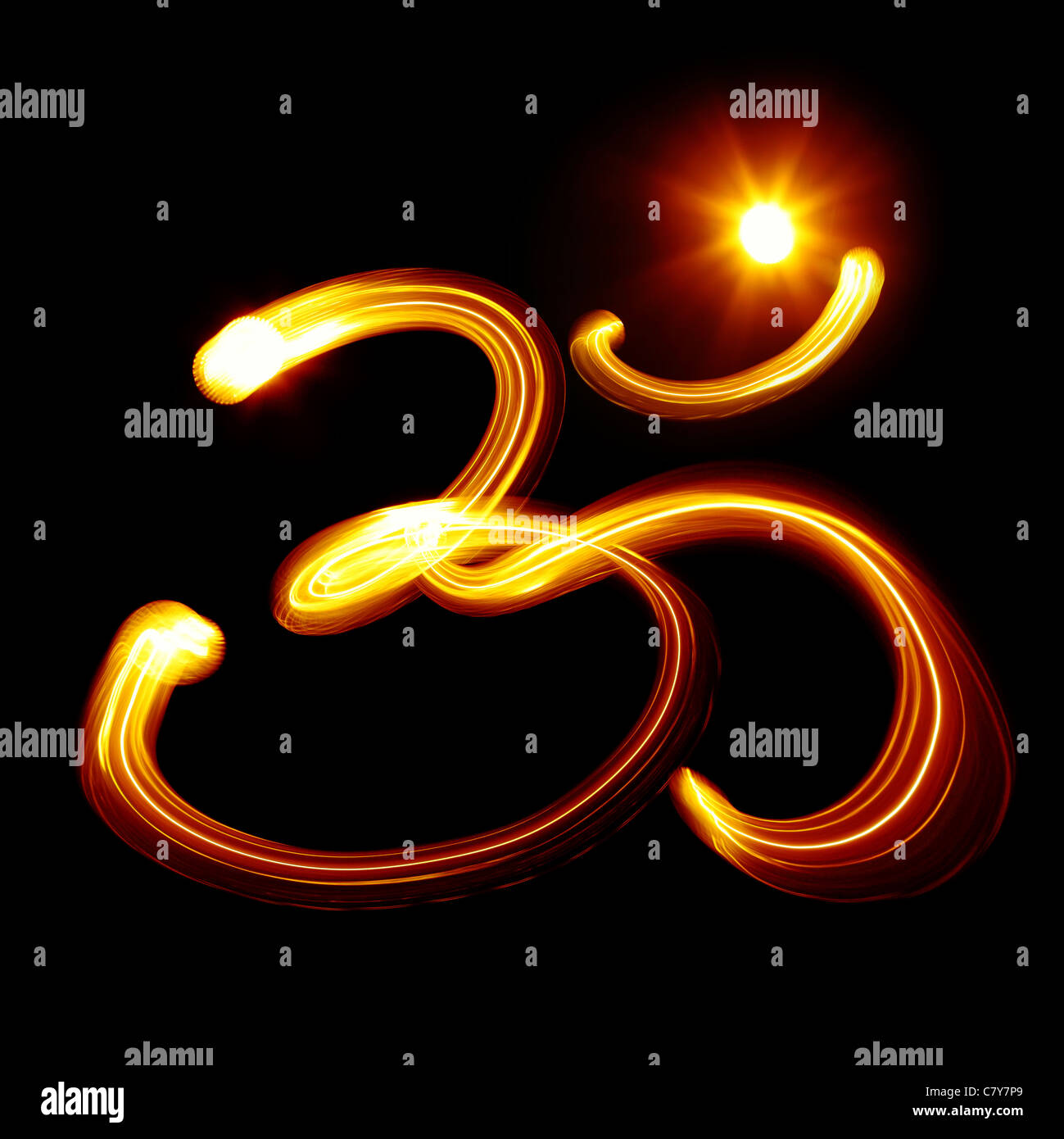 Sacred Om syllable created by light over black background Stock Photo