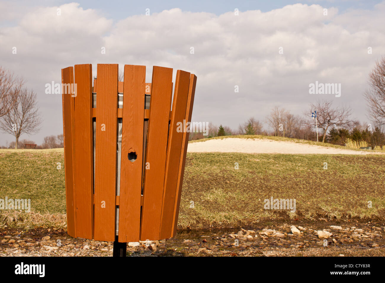 Trash can in wooden container at golf course Stock Photo