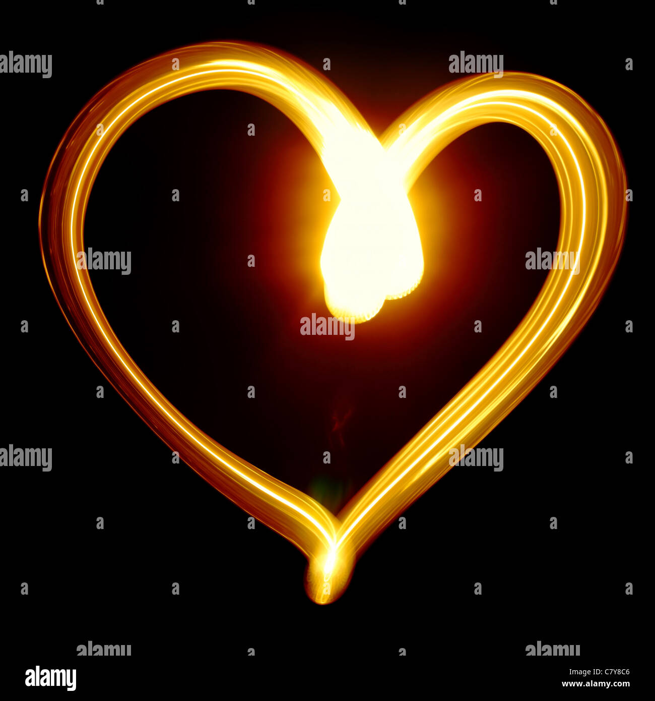 Heart symbol created by light over black background Stock Photo - Alamy