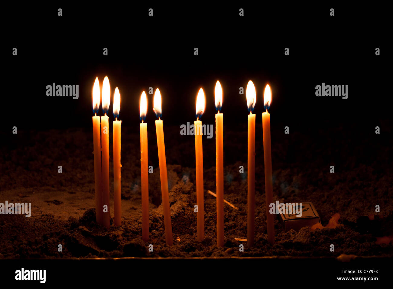 Candles firing and illuminating in the church Stock Photo