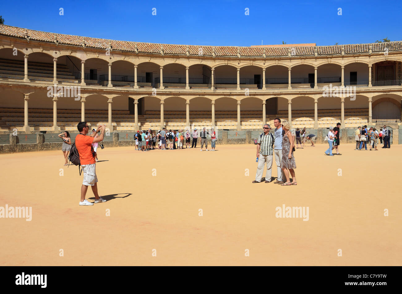 Tourists being photographed within the bull ring at Ronda, Andalusia, Spain Stock Photo