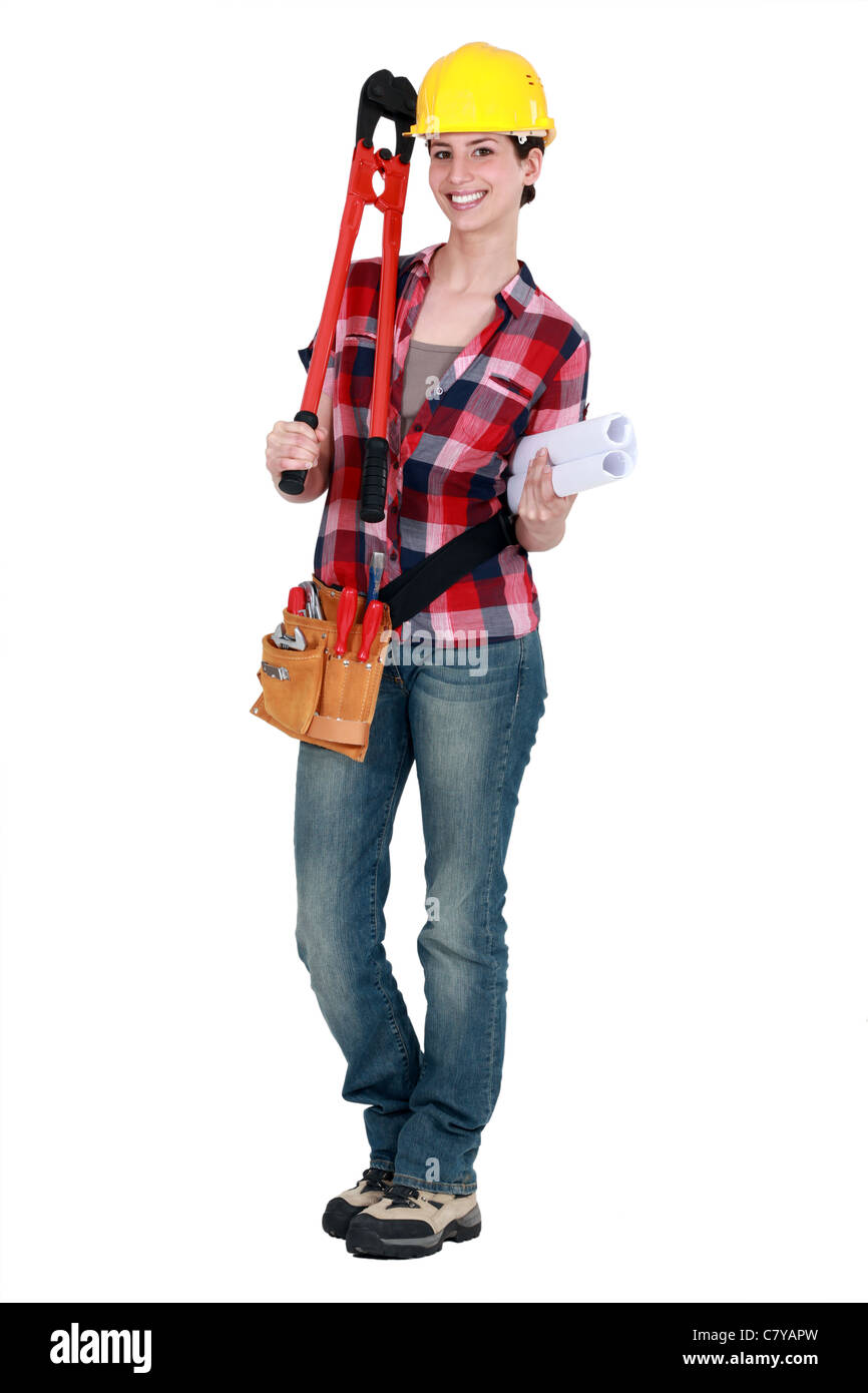 Tradeswoman holding large clippers and rolled-up drawings Stock Photo