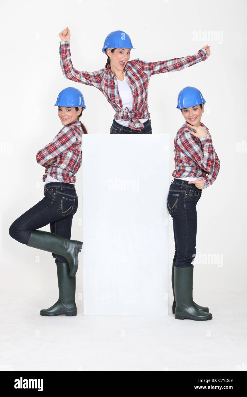 Photomontage of playful girl with hardhat and white sign Stock Photo