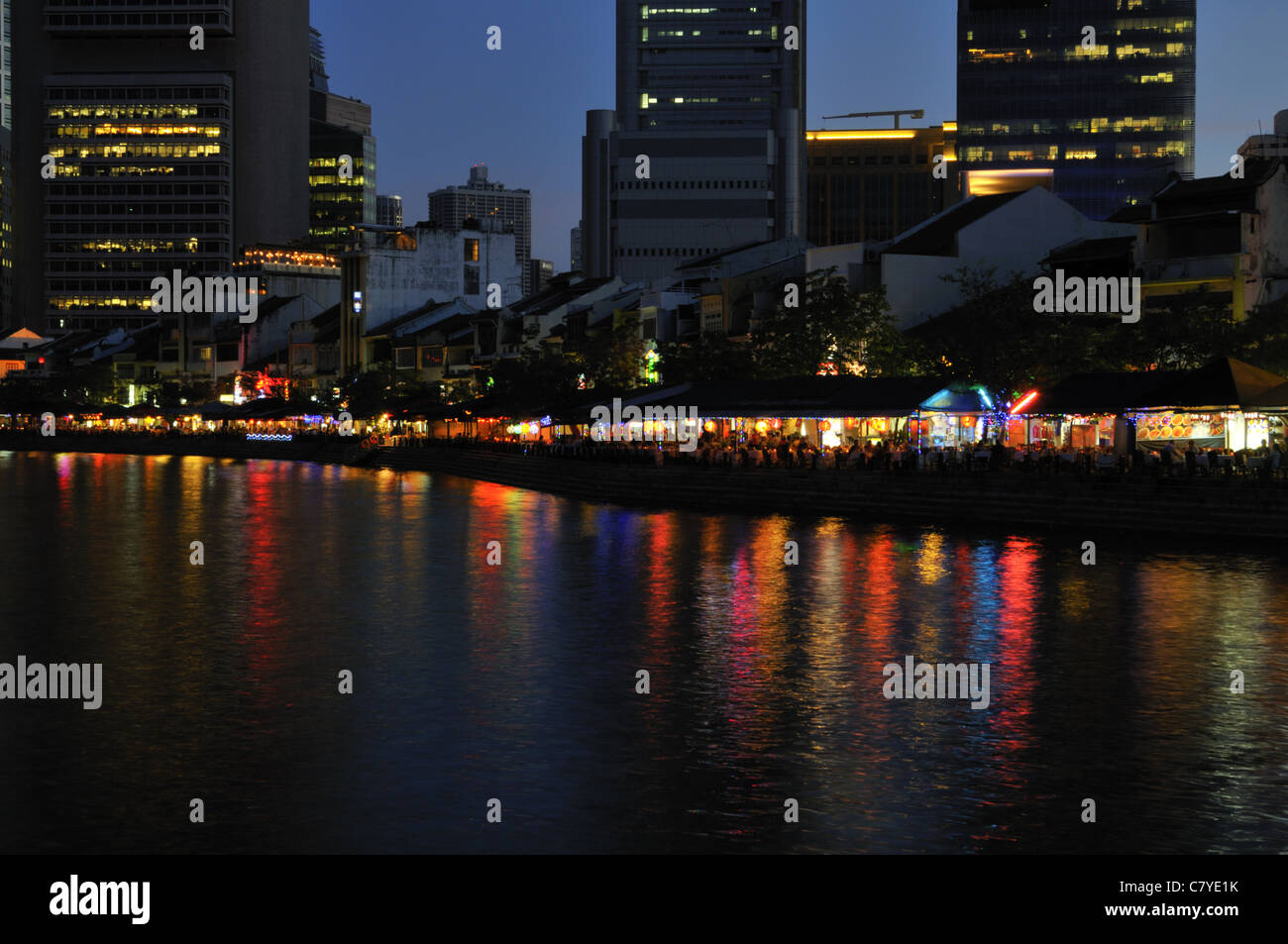 Lights from restaurants on Boat Quay by Singapore river at night Stock