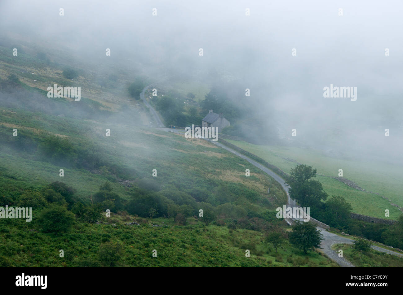 Traditional Farmhouse surrounded by fog in the Nantgwynant Valley, Snowdonia National Park, North Wales, UK Stock Photo