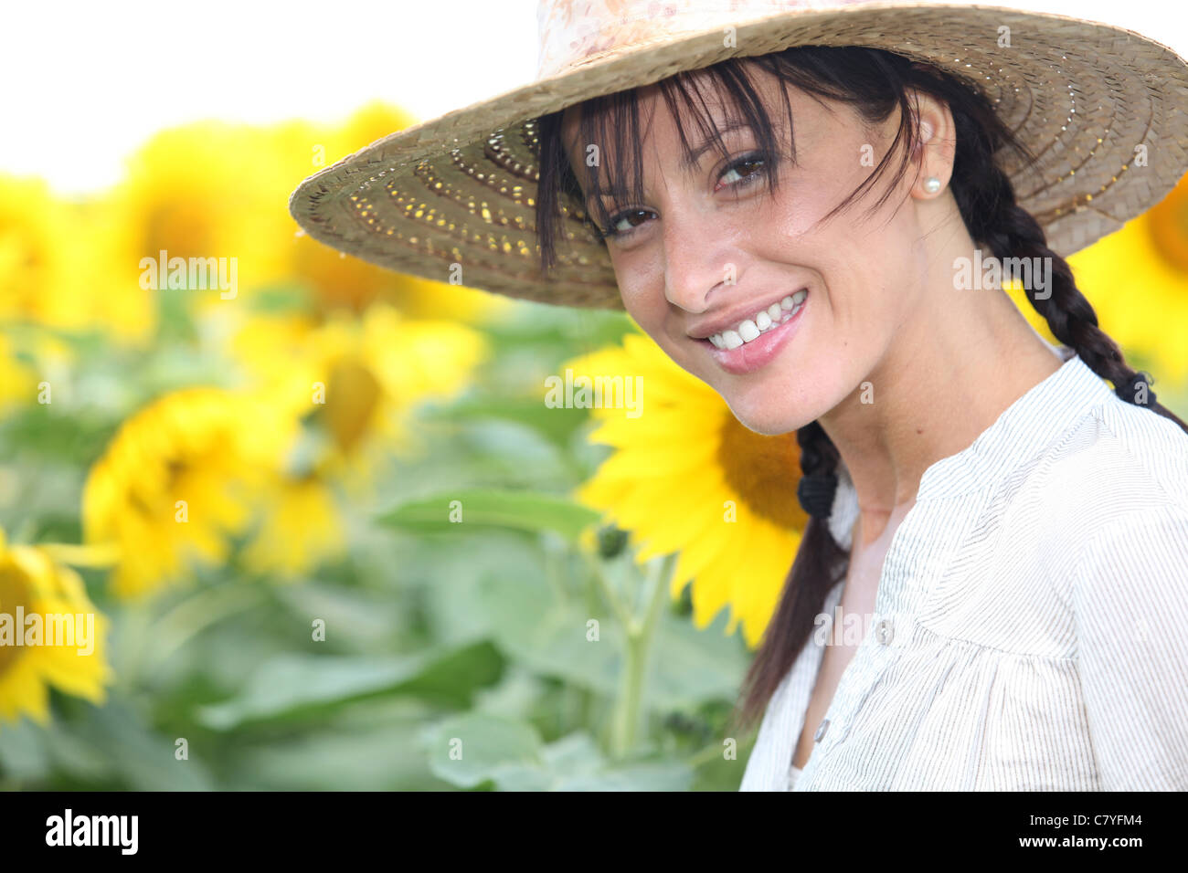 Woman in a straw hat in a sunflower field Stock Photo - Alamy