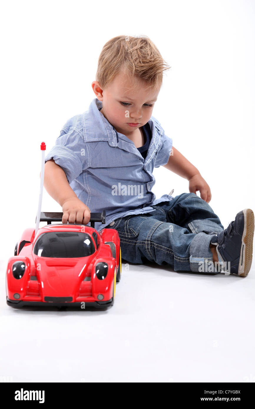 Young boy playing with a toy car Stock Photo - Alamy