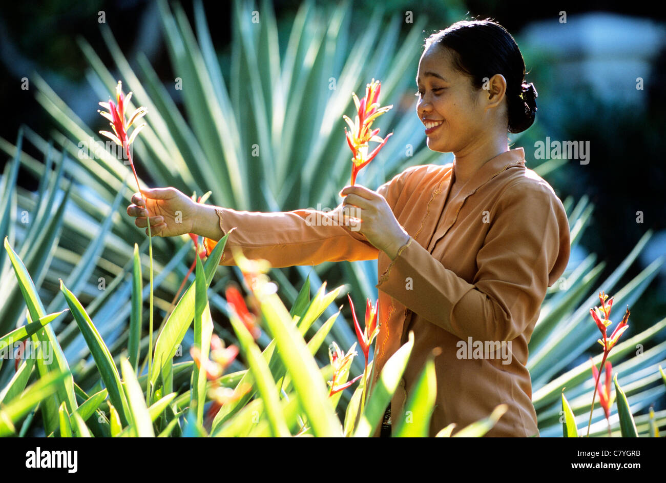 Malaysia, Kuala Dungun, woman with flowers Stock Photo