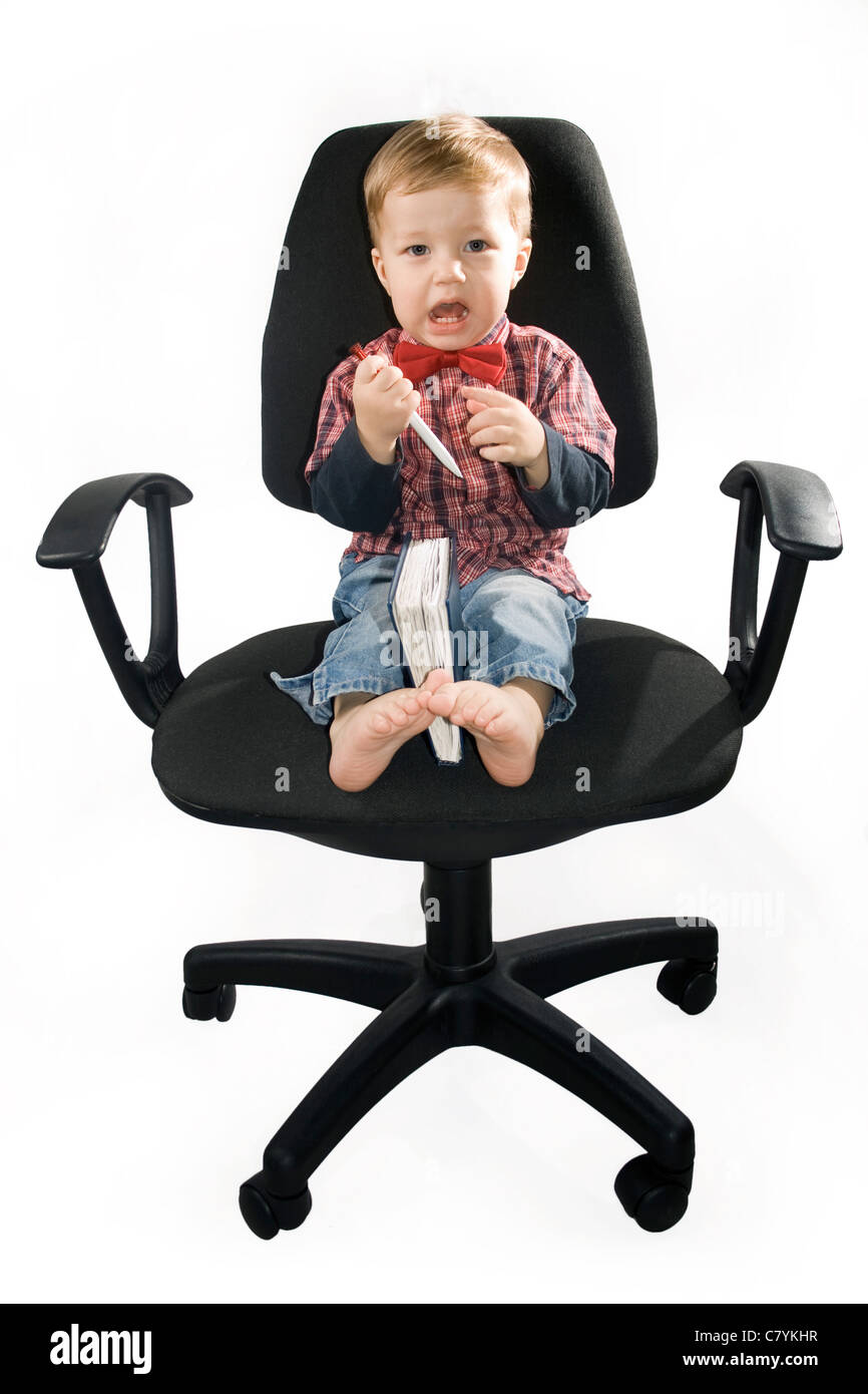 Little boy smiling sitting in the armchair Stock Photo