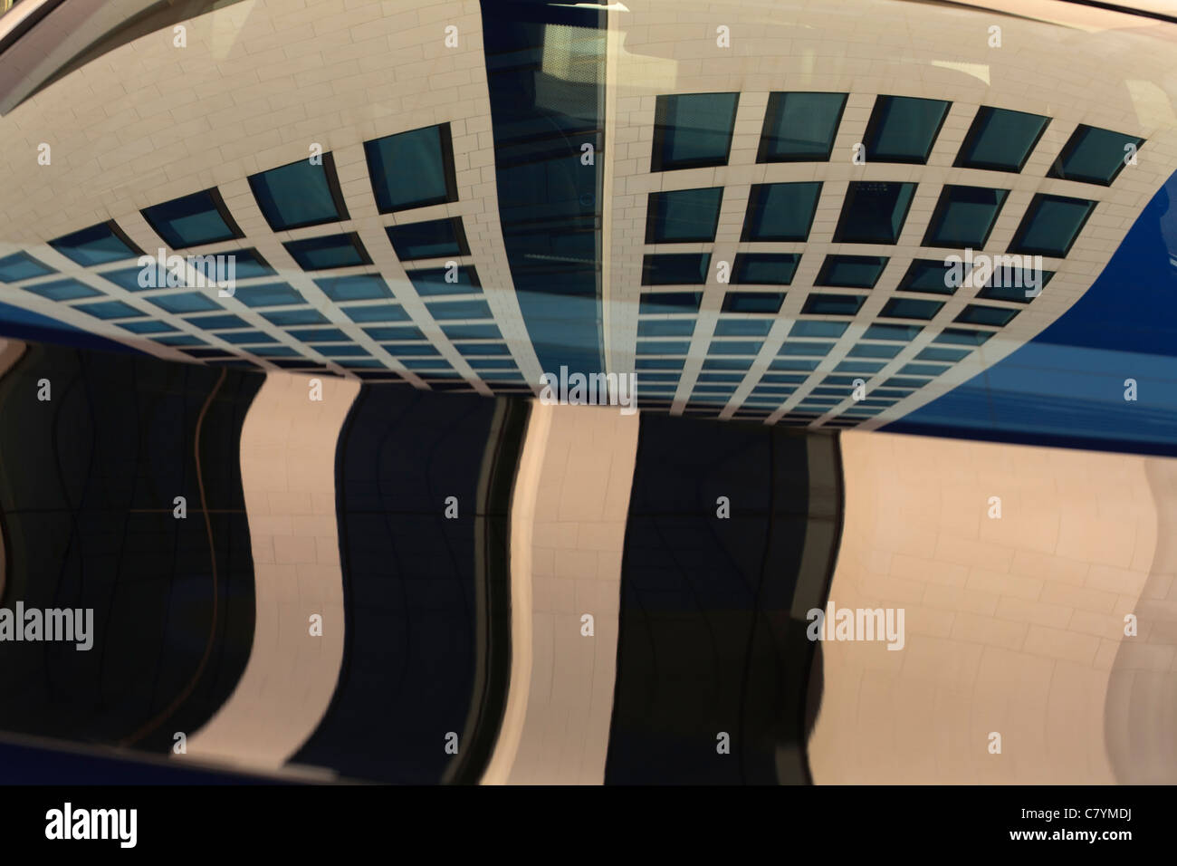 Abstract image of an office building reflected in the window of a car (BMW) in Frankfurt am Main. Stock Photo
