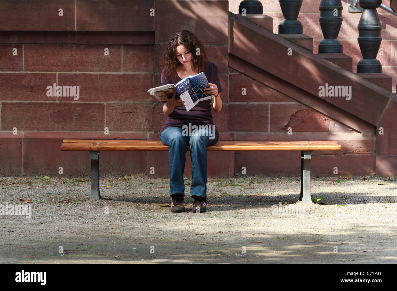 Woman Reading A Guide Women reading a city guide in Frankfurt Stock Photo - Alamy