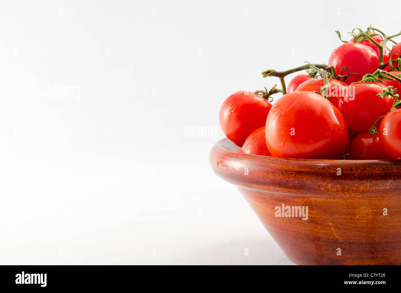 cherry tomatoes in wooden bowl Stock Photo - Alamy