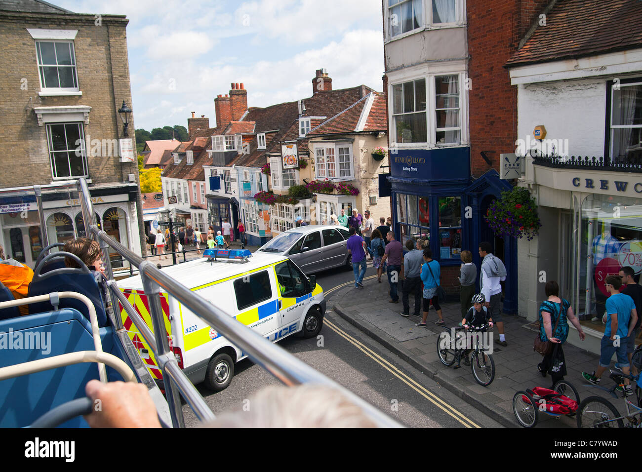 Police van blocking the road for a fire incident in Lymington High Street. Taken from an open top bus. Stock Photo