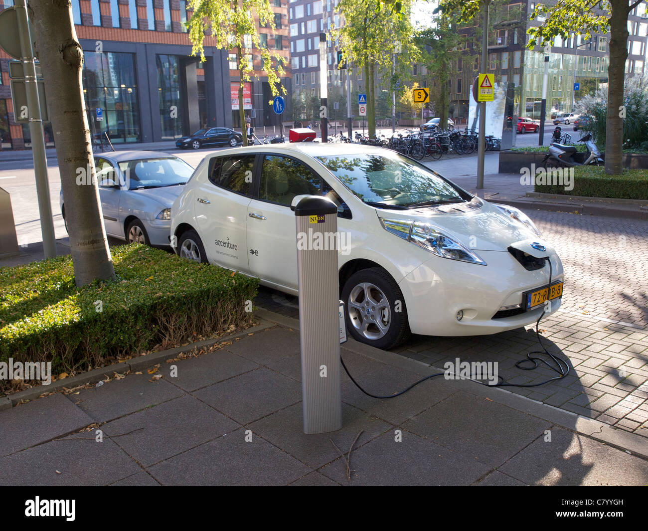 Nissan Leaf electric car plugged in and being charged in Amsterdam, the Netherlands Stock Photo
