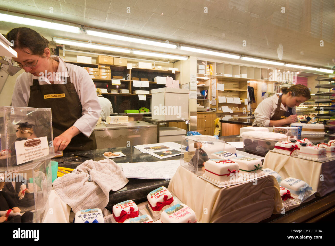 Two ladies decorating cakes in the Cake Shop, Indoor Market, Oxford