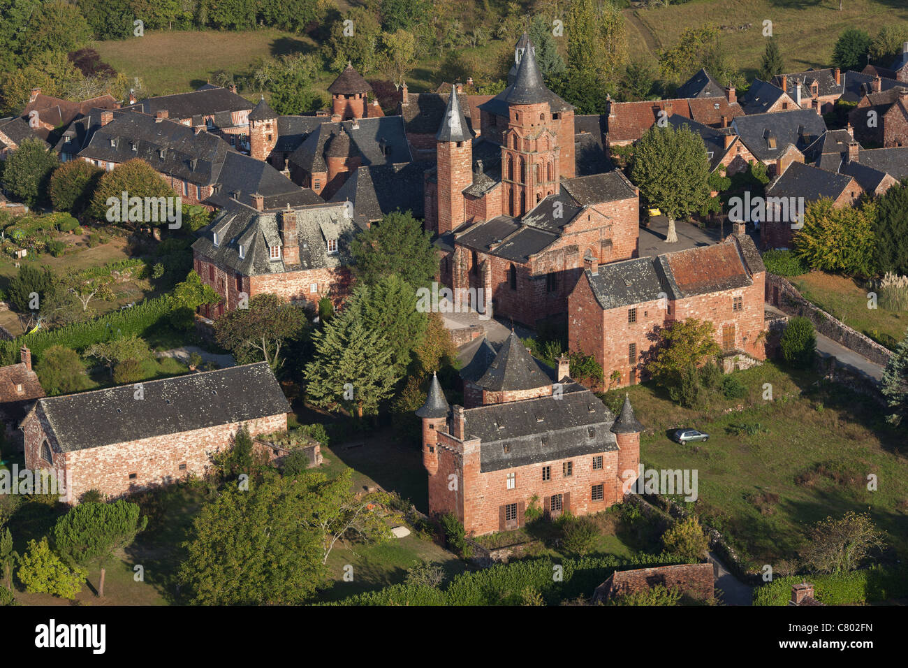AERIAL VIEW. Medieval village where all the buildings are built with the same red sandstone. Collonges-la-Rouge, Corrèze, Nouvelle-Aquitaine, France. Stock Photo