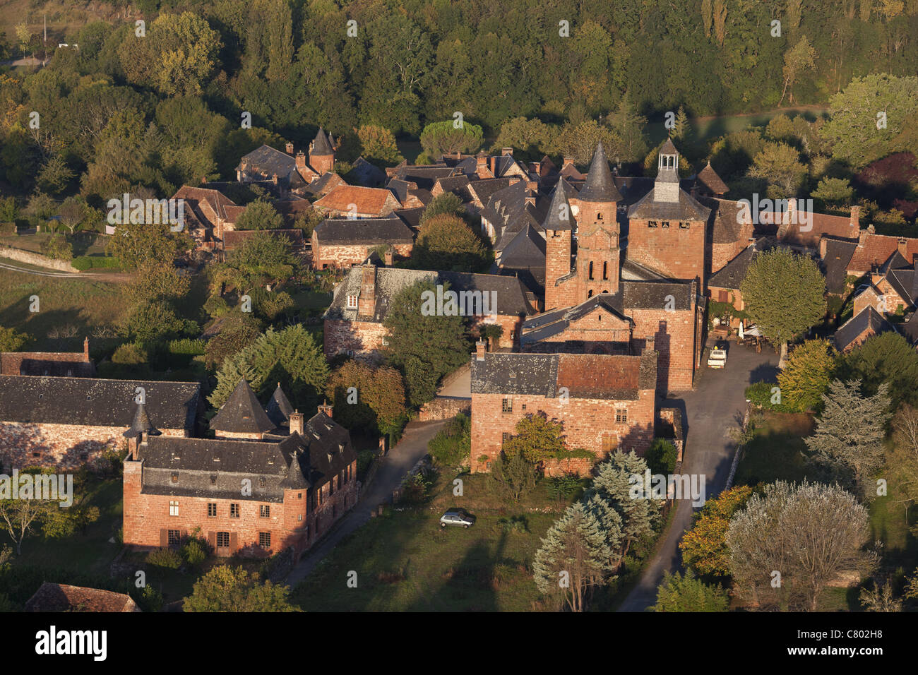AERIAL VIEW. Medieval village where all the buildings are built with the same red sandstone. Collonges-la-Rouge, Corrèze, Nouvelle-Aquitaine, France. Stock Photo