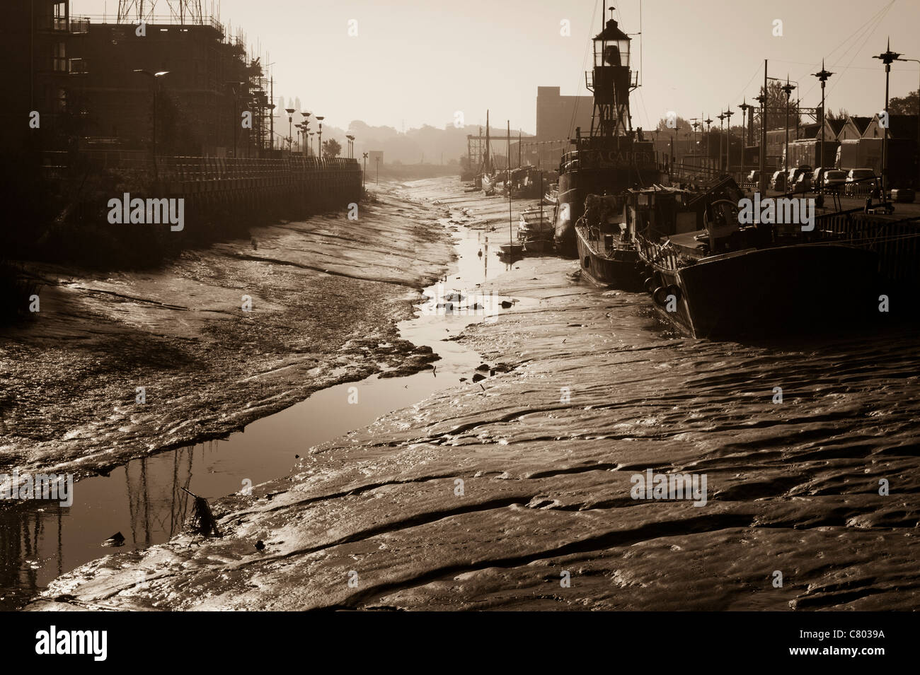 Boats on the mud at low tide alongside King Edward Quay in Hythe, Colchester, England. Stock Photo