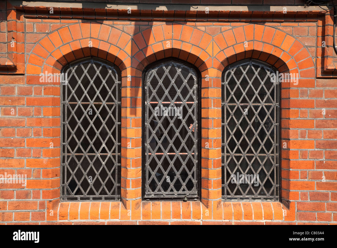 England, West Sussex, Arundel, detail of red brick building with lead light windows. Stock Photo