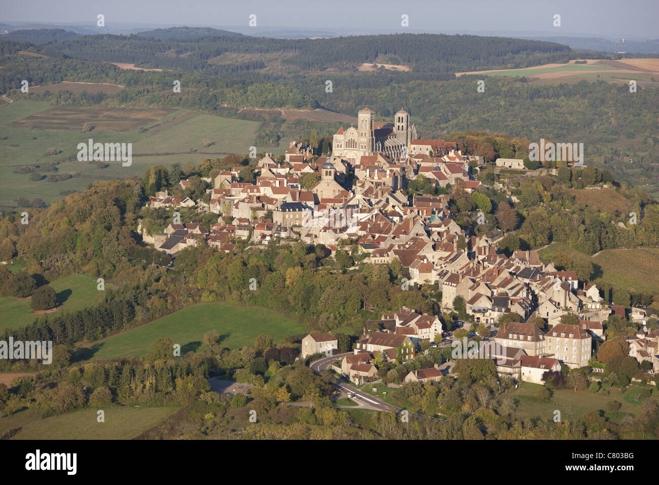 AERIAL VIEW. Small hill town in the countryside, St Mary Magdalene basilica at the top. Vezelay, Yonne, Bourgogne-Franche-Comté, France. Stock Photo