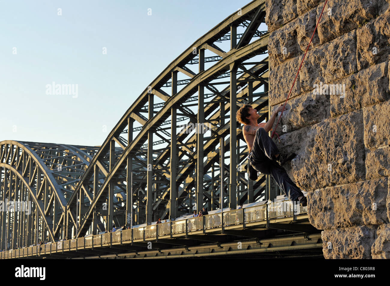 Climber at the Hohenzollernbrücke in Cologne Stock Photo