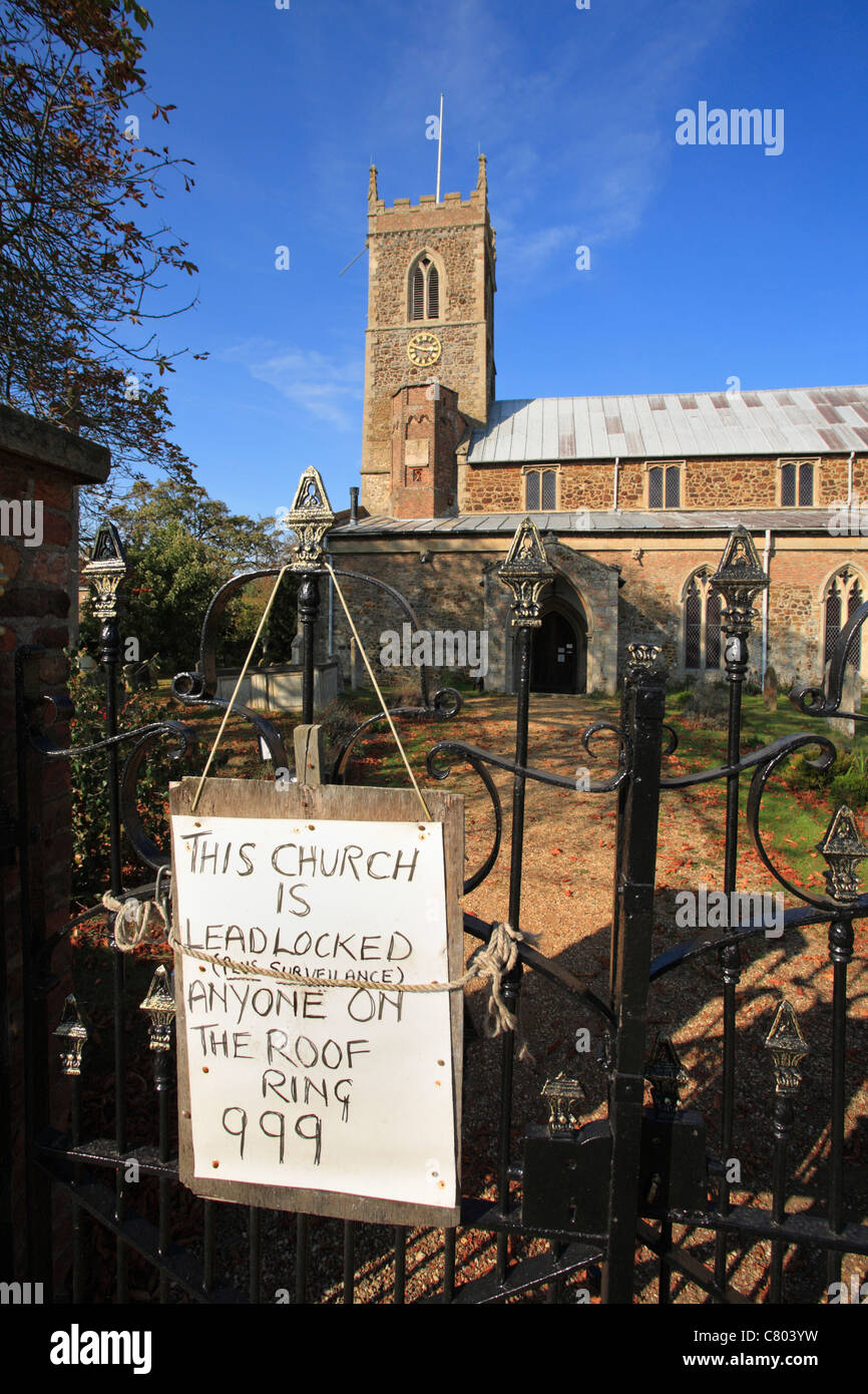 Sign warning 'This church is lead locked. Anyone on the roof call 999.' at St. Peter and St. Paul's parish church at Watlington. Stock Photo