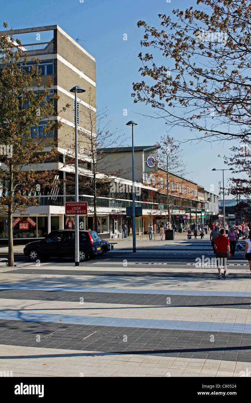 Trees decorate the streets and soften the outline of shops and office blocks in the town centre of Corby Stock Photo
