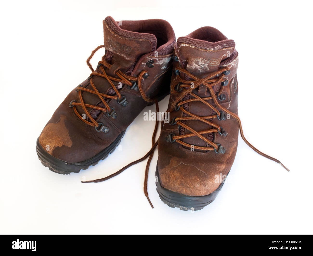 Pair of old walking boots photographed against a white background Stock