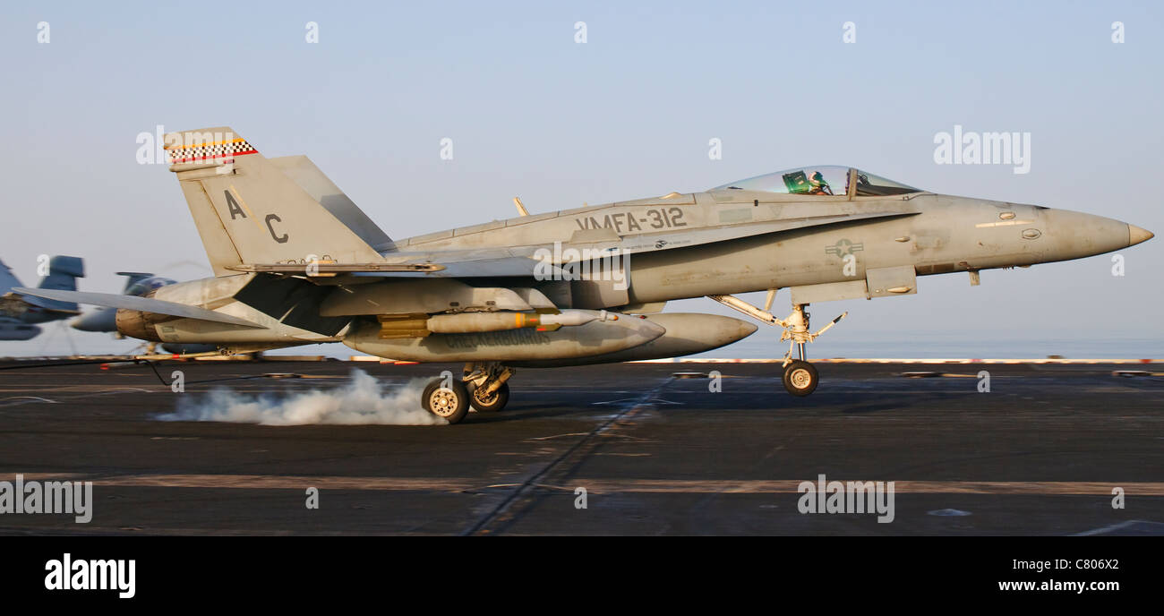 An F/A-18 Hornet assigned to VMFA-312 lands aboard USS Harry S. Truman after a mission over Afghanistan. Stock Photo