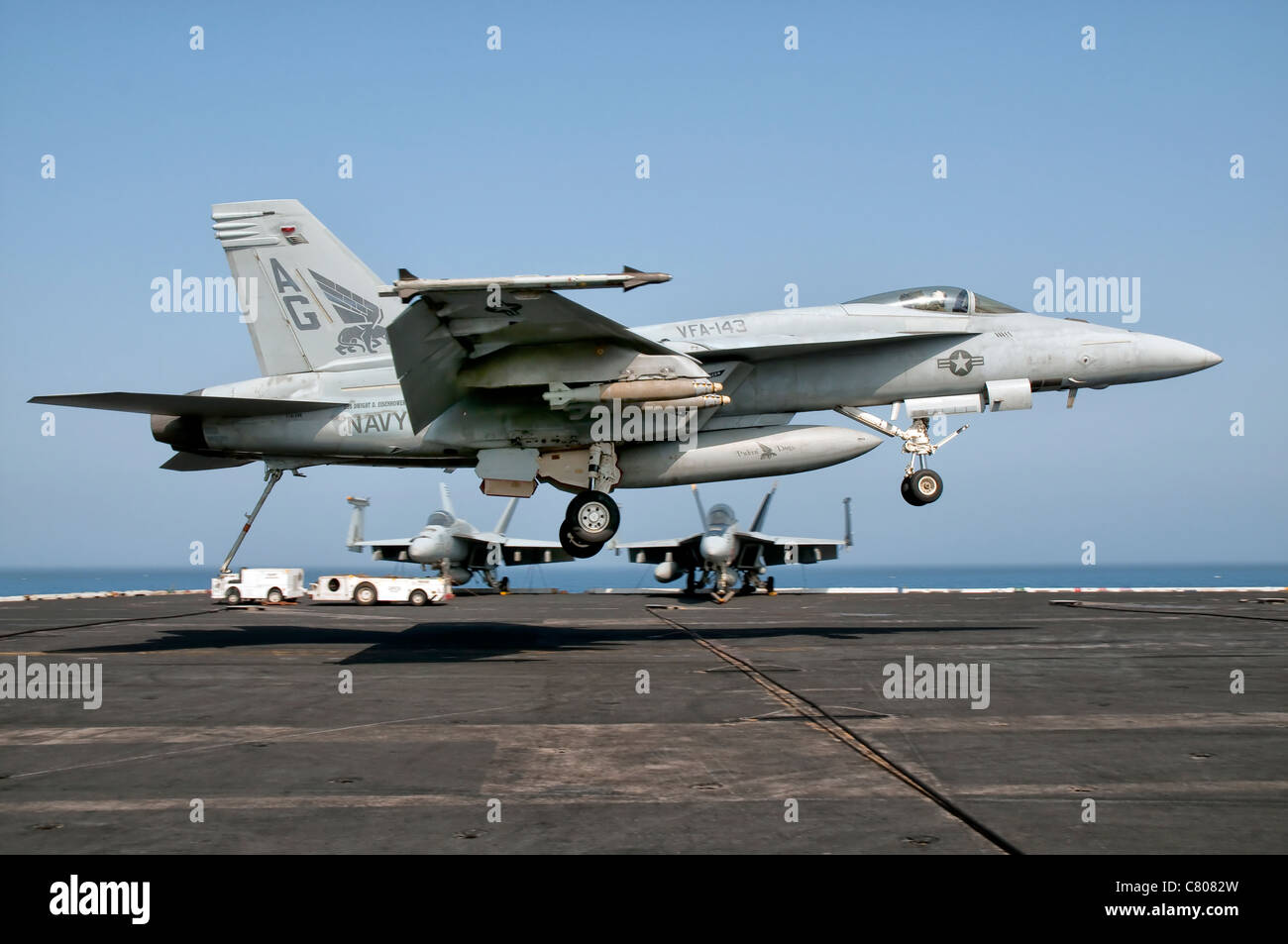 A US Navy F/A-18E Super Hornet prepares to land aboard USS Eisenhower. Stock Photo