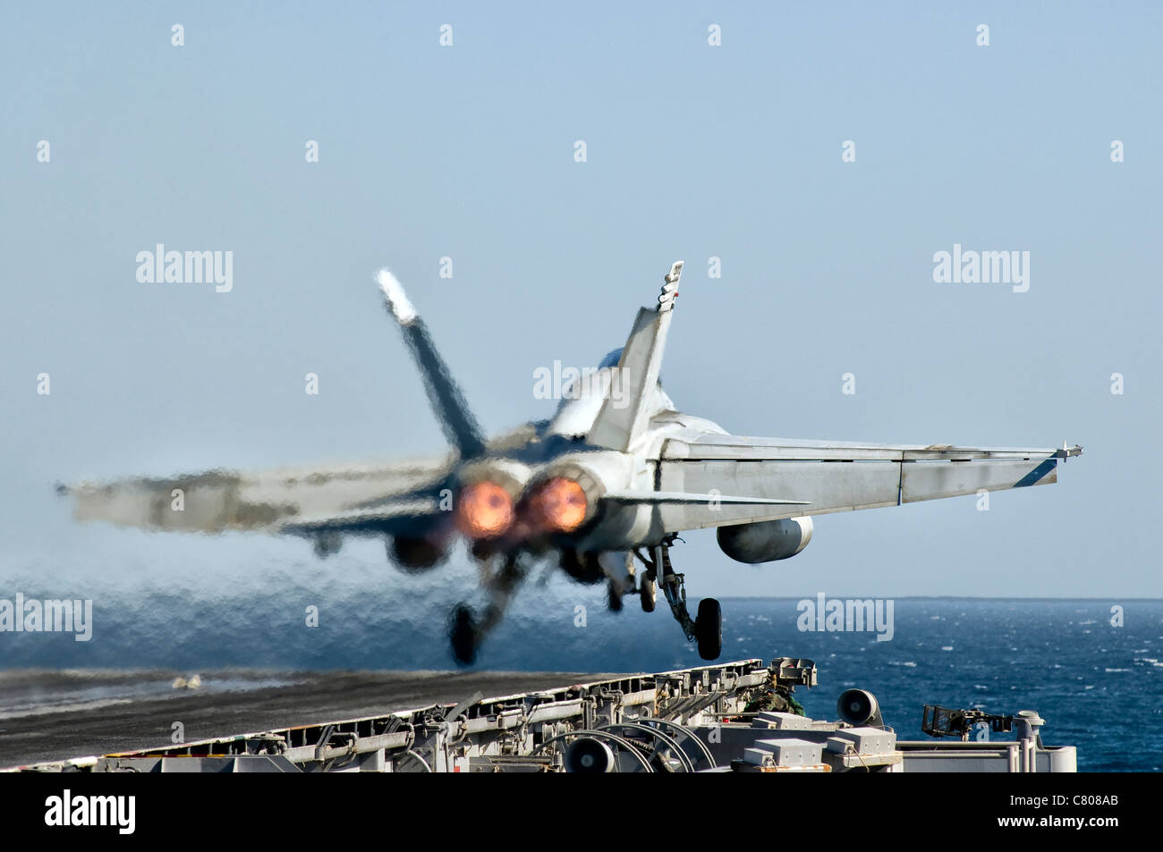 A US Navy F/A-18F Super Hornet launches from the flight deck of aircraft carrier USS Nimitz. Stock Photo