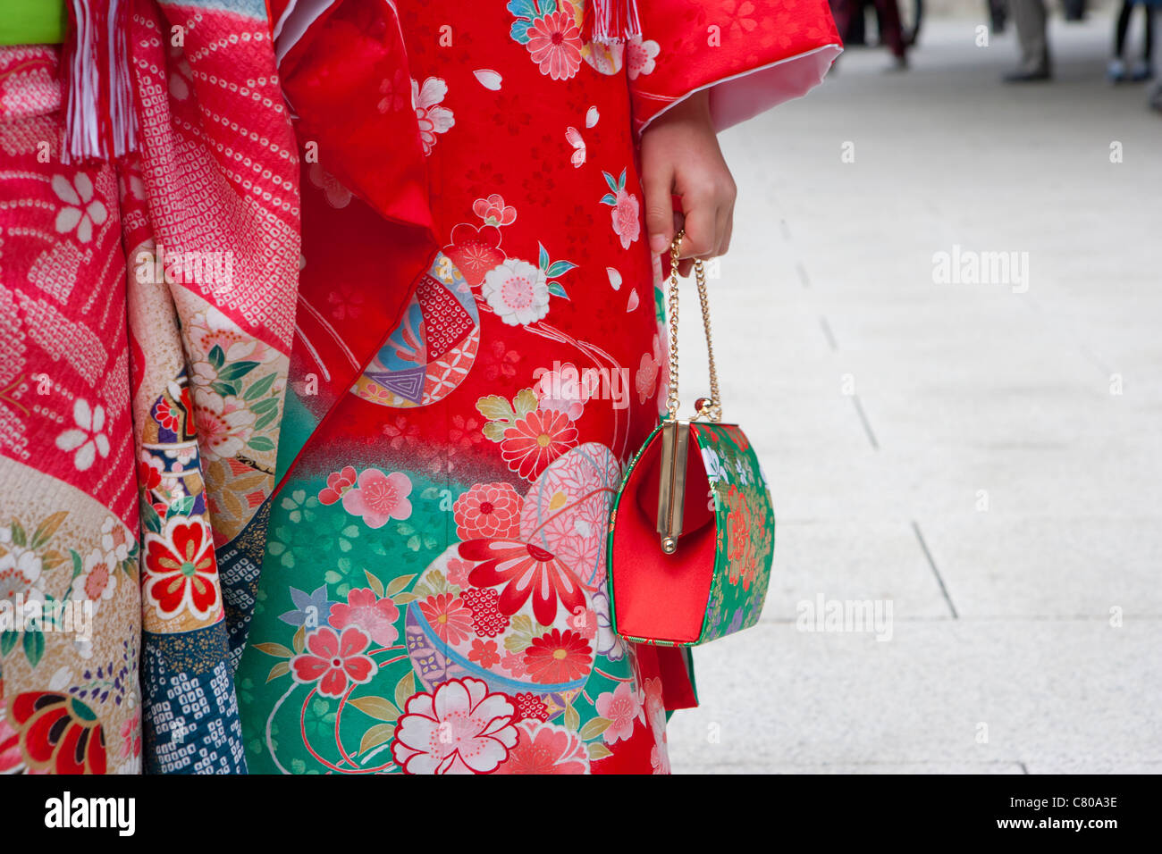 Close-up of young girl's hand holding purse, Children's Day at Meiji Shrine, Tokyo Stock Photo