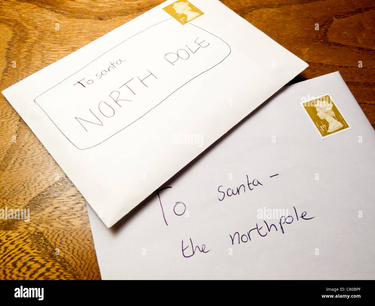 Letters to Father Christmas or Santa Claus from a child ready to be posted to the North Pole with a UK first class stamp Stock Photo