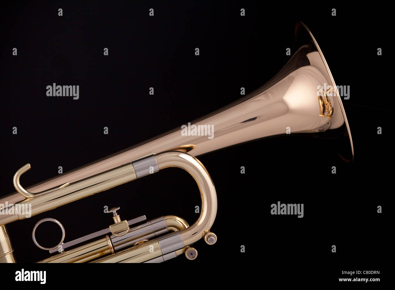 A gold and brass trumpet or isolated against a black background