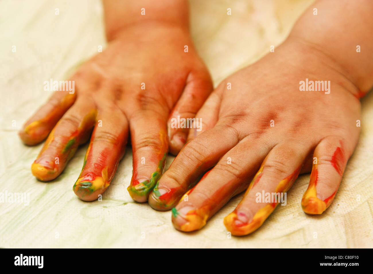 Young child painting with hands - shallow depth of focus Stock Photo