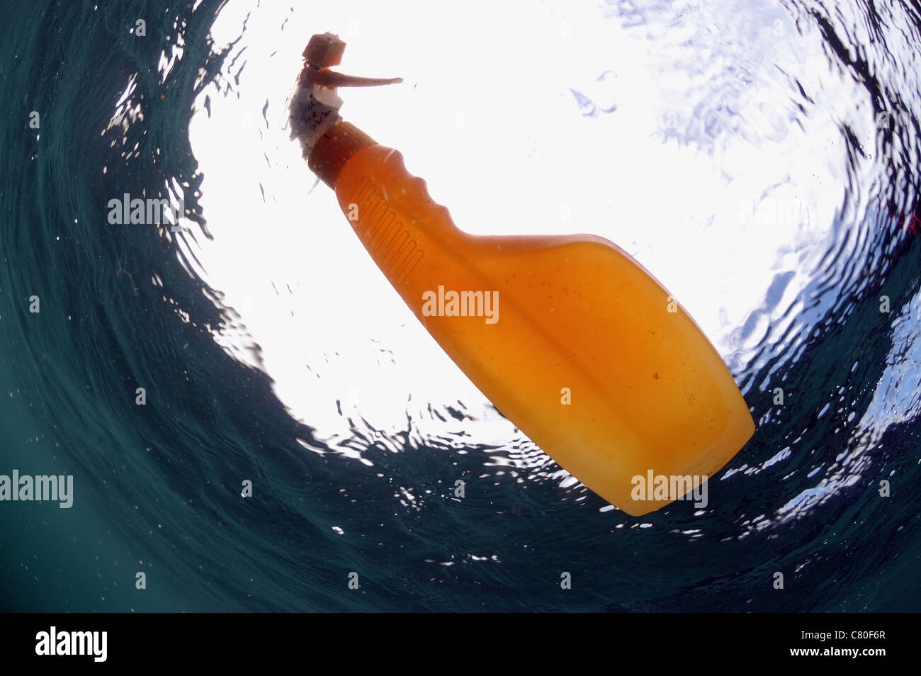 Spray bottle floating in the sea, Kimmeridge bay Dorset. Stock Photo