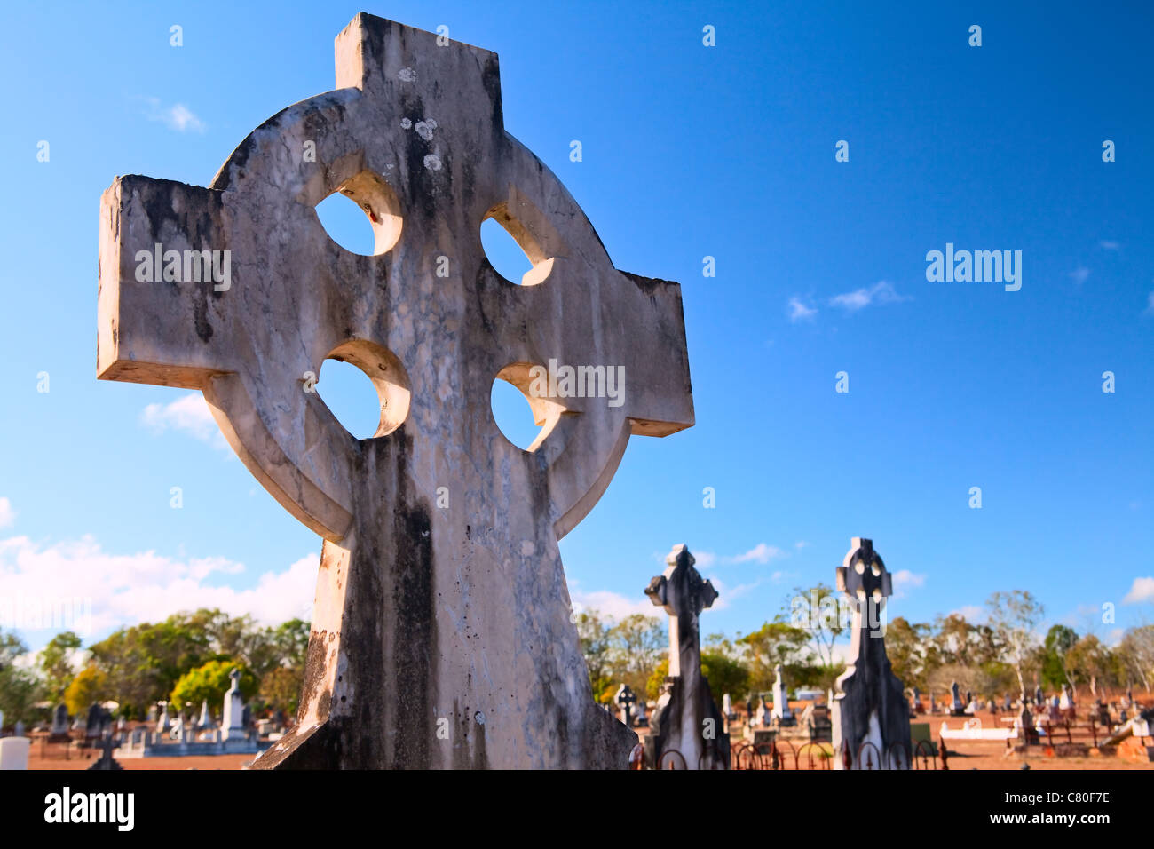 celtic cross on australian graveyard old ancient burial ground cemetery tombstone with copy space in blue sky Stock Photo