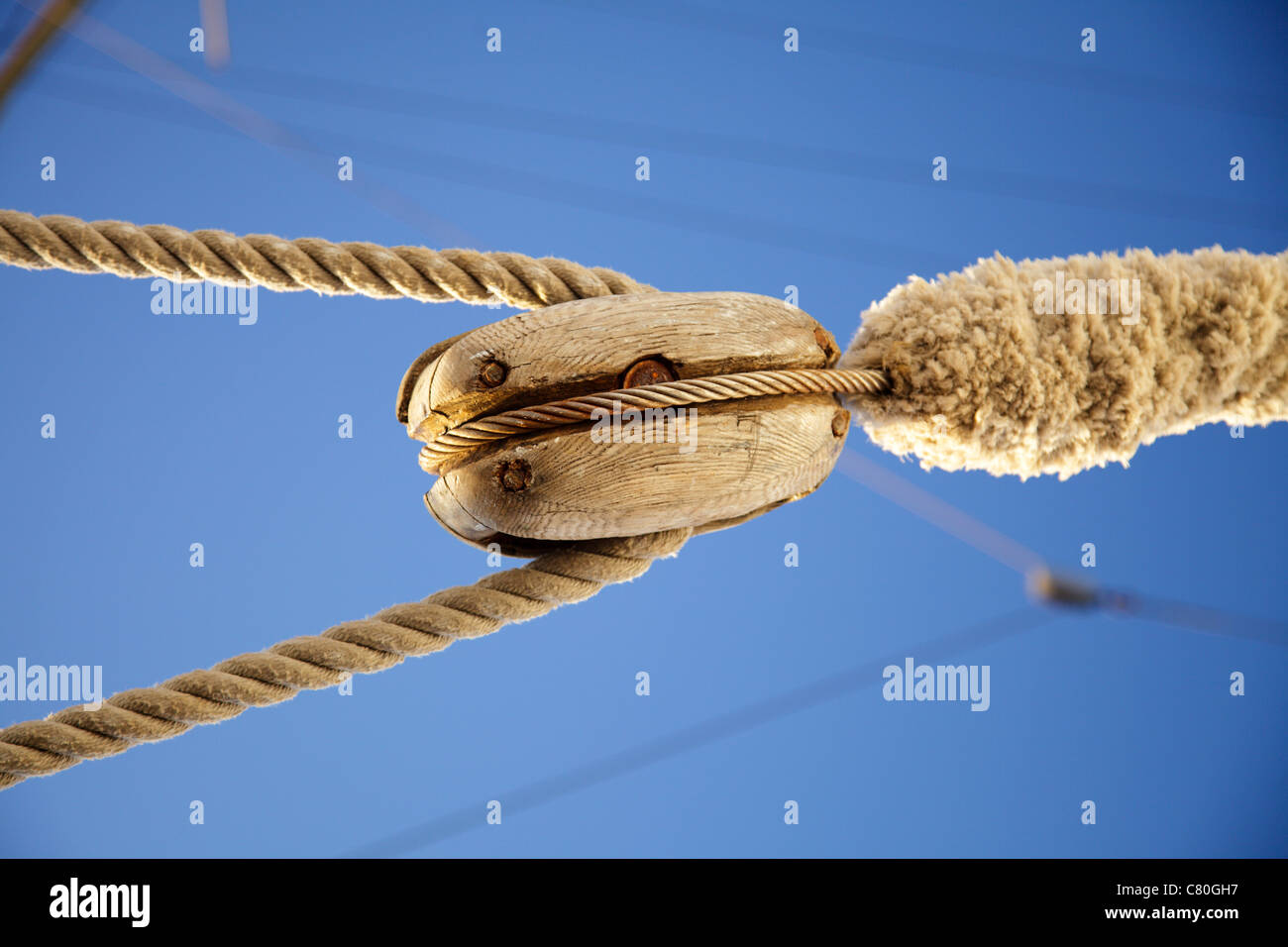 view of a blue sea through the wires, rope Detail, rigging of boat